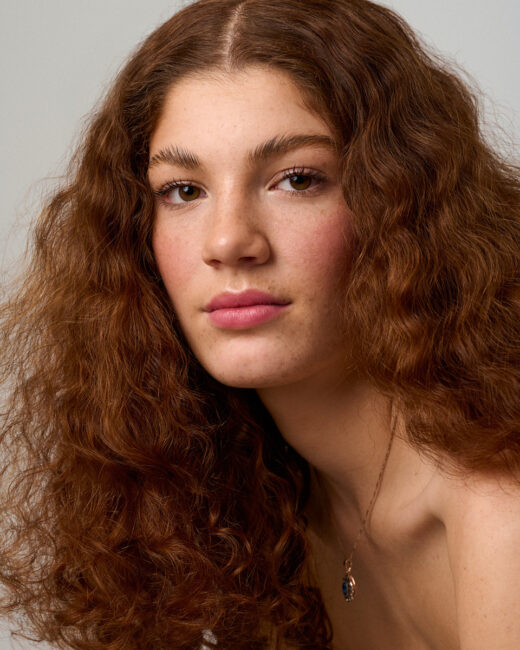 Natural beauty portrait with textured hair and minimal makeup